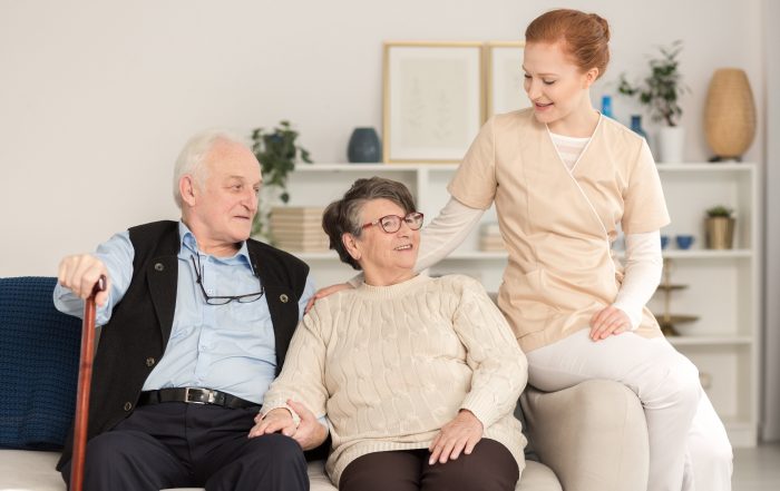 seniors in assisted living home being helped by a nurse