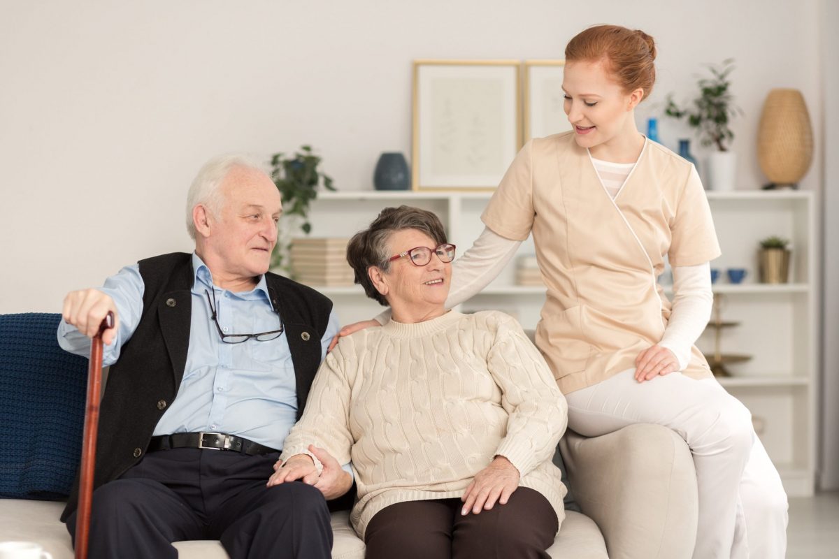 seniors in assisted living home being helped by a nurse