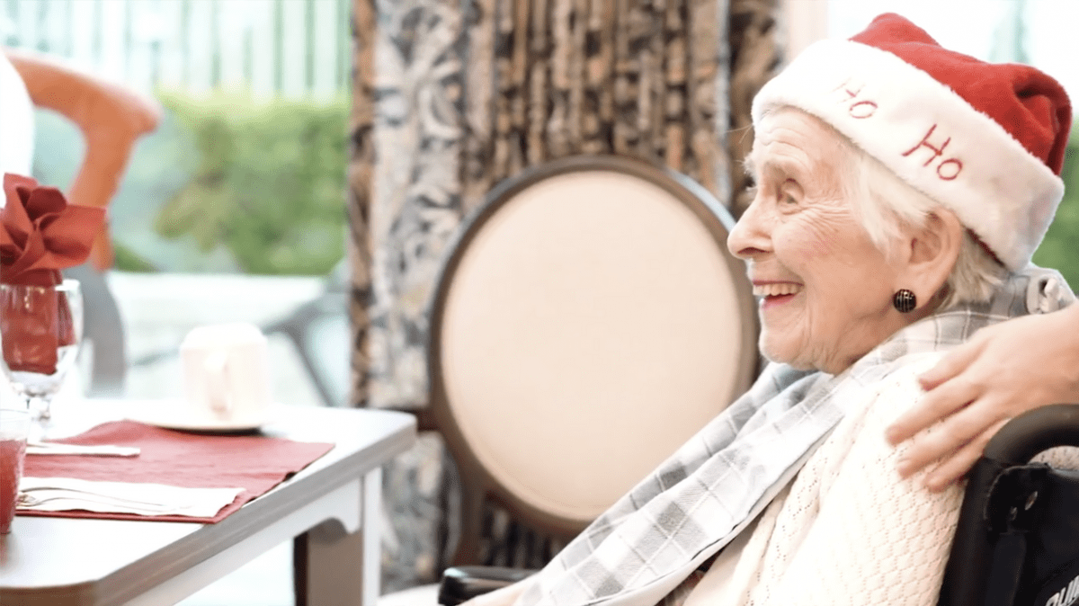 smiling elderly woman enjoying Christmas celebration