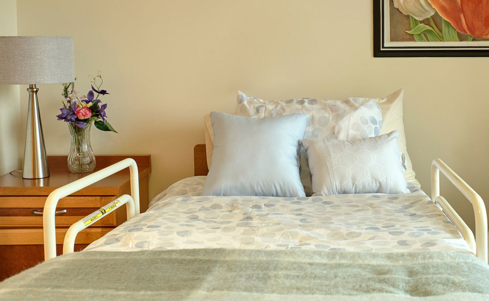 Lynn Valley Care Centre bed with assistance railings in our facilities