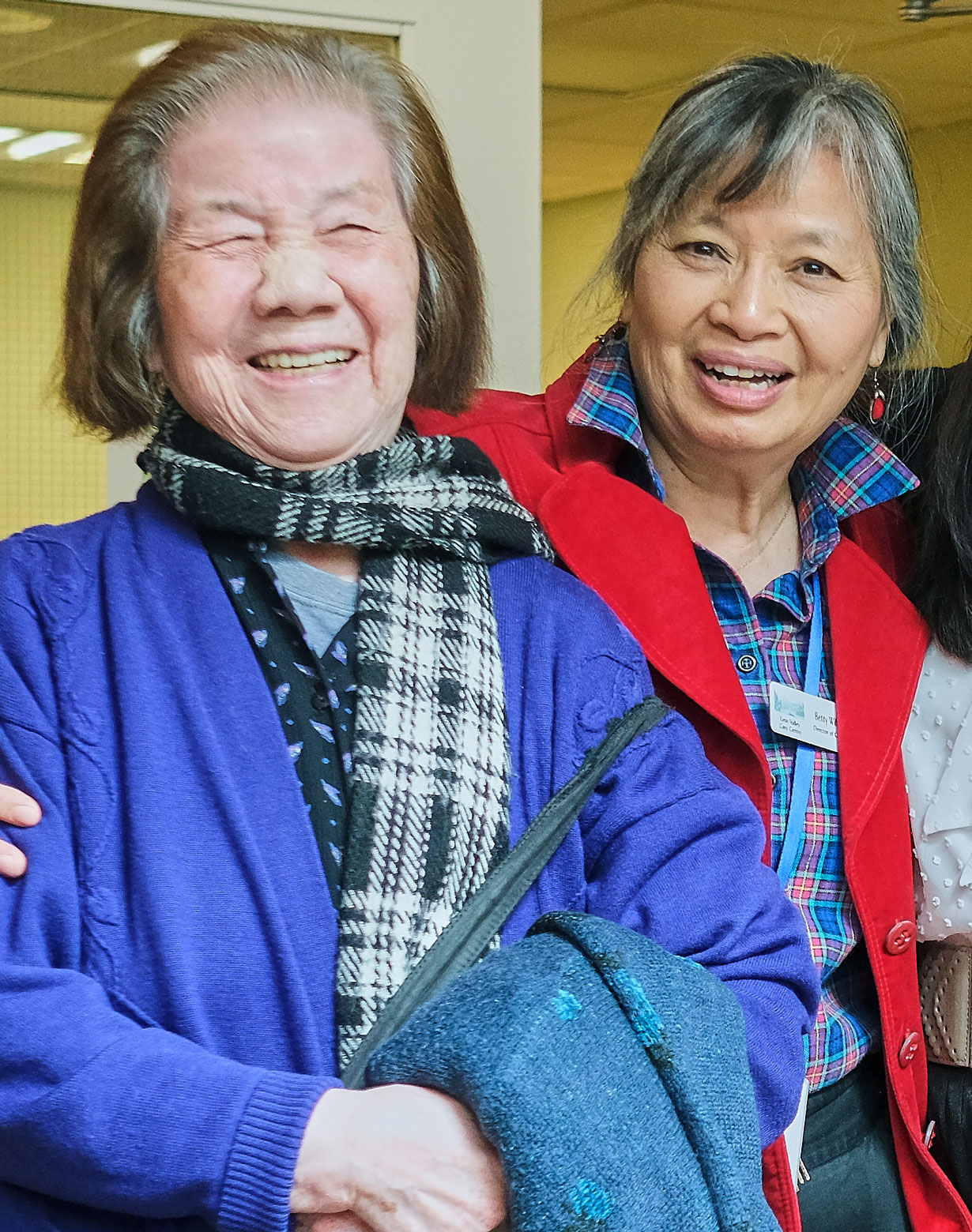 two elderly asian women smiling at lynn valley care centre