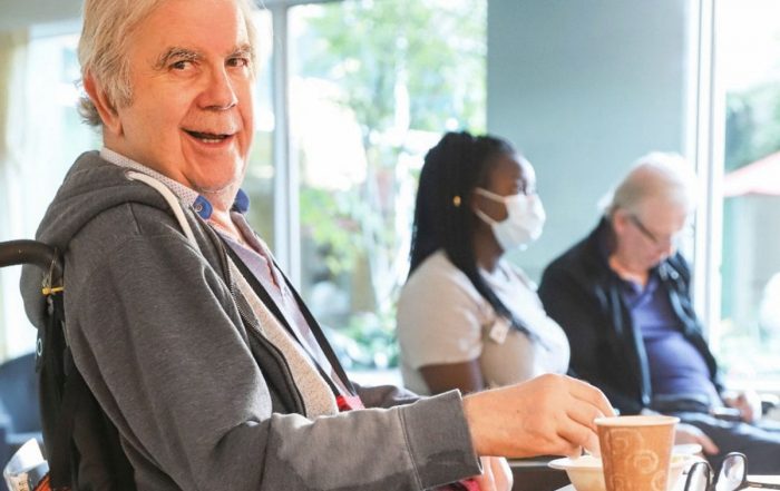 lynn valley care centre, care home, senior in wheelchair smiling