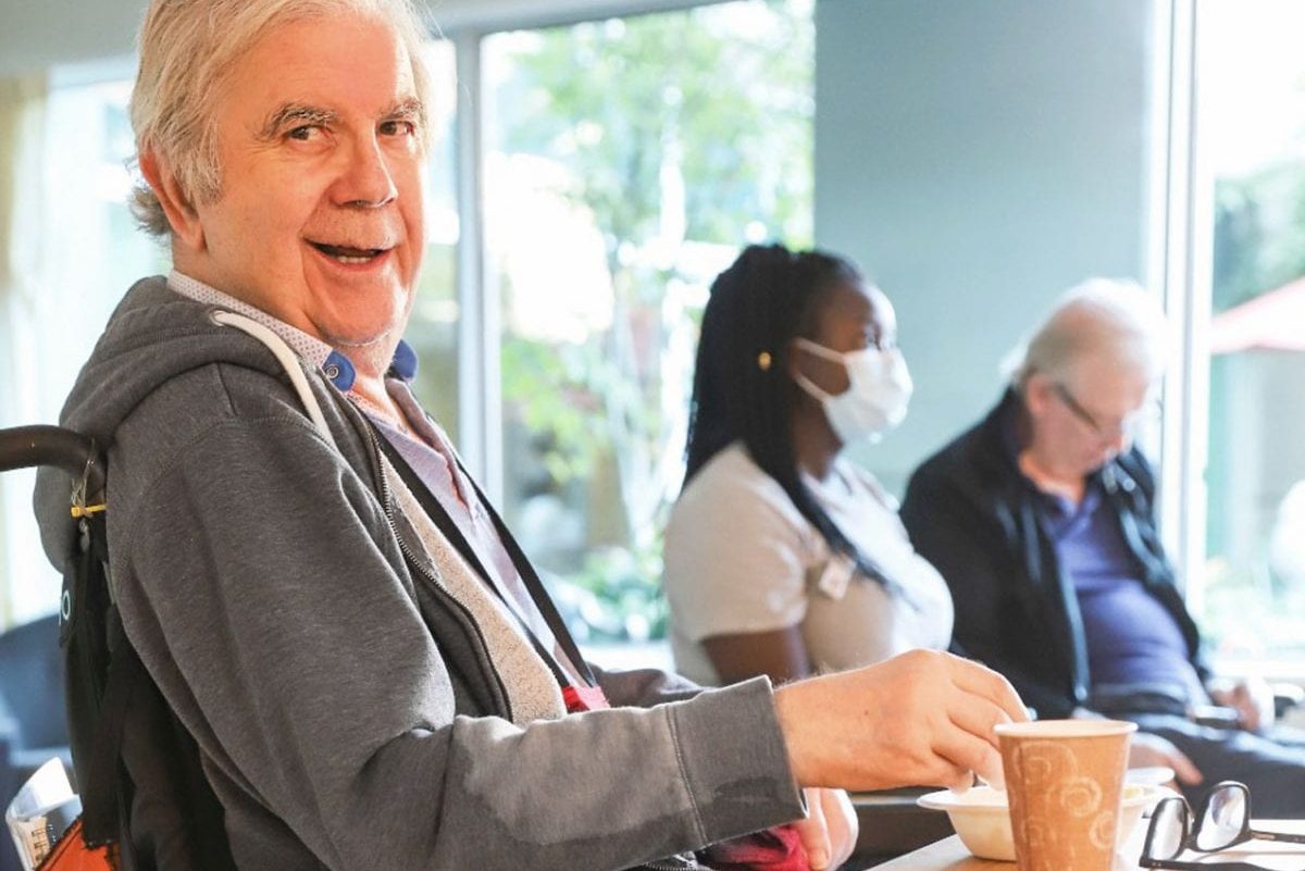 lynn valley care centre, care home, senior in wheelchair smiling