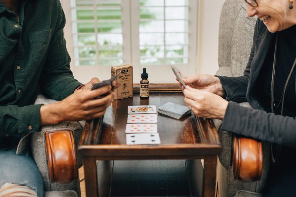 older people learning to play cards and laughing