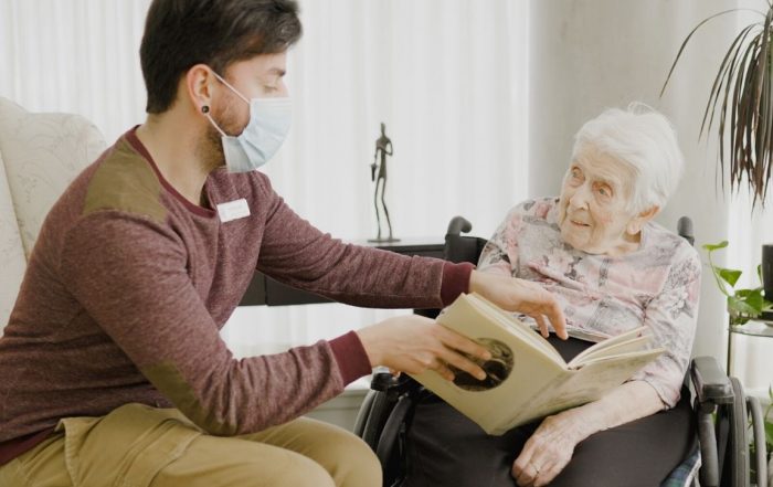 Man helping a senior loved one into a long-term care