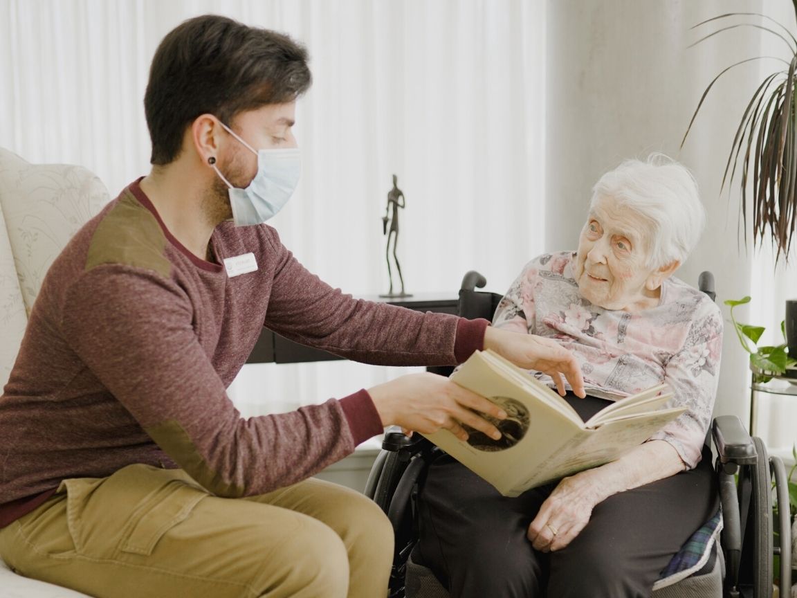 Man helping a senior loved one into a long-term care