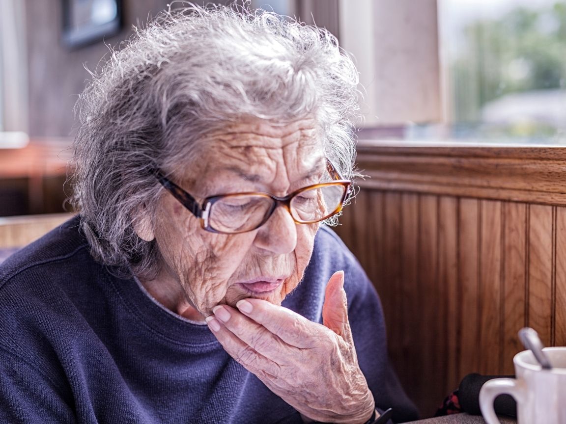 woman having a senior moment looking at a menu confused