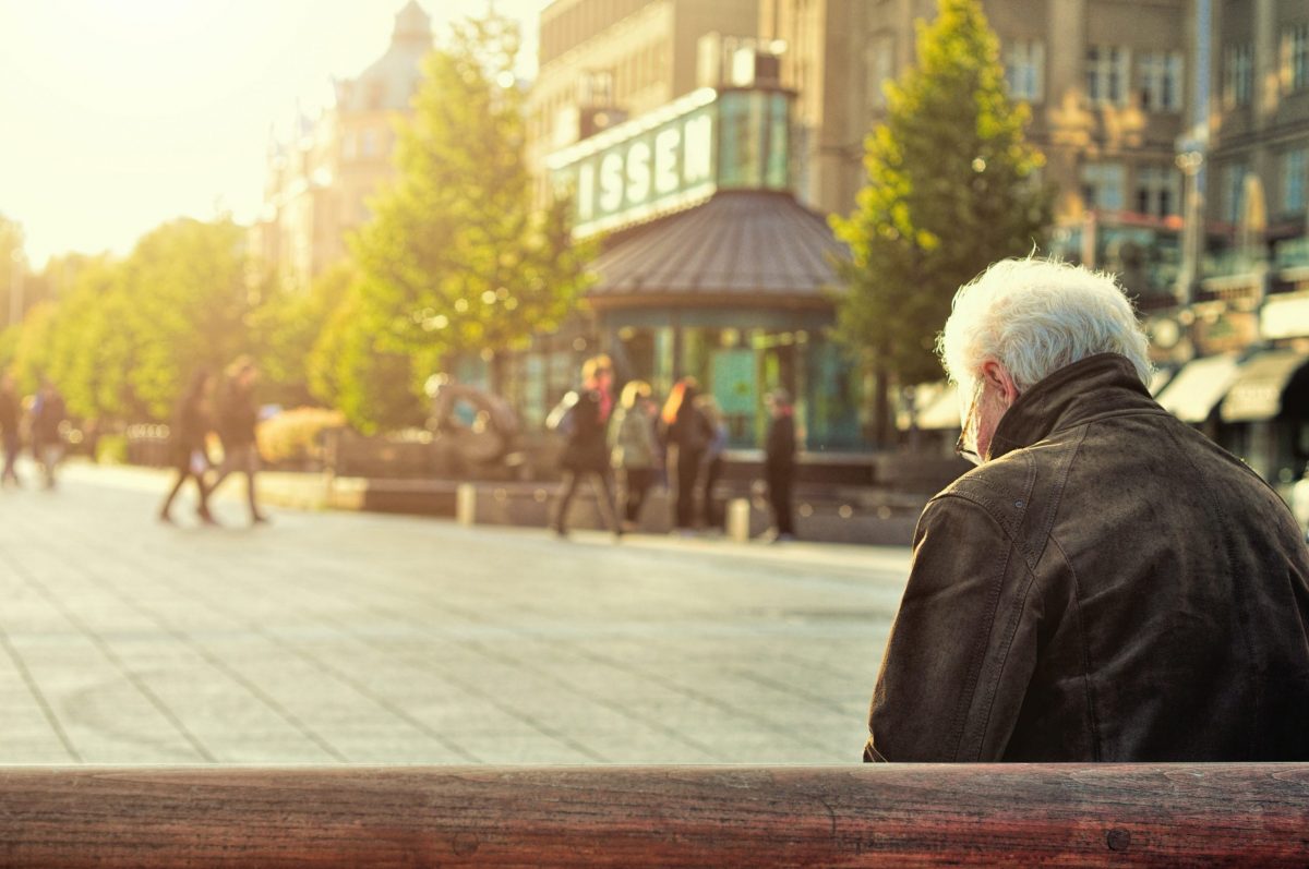 elder man sitting outside on bench