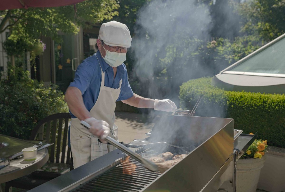 man barbequing chicken