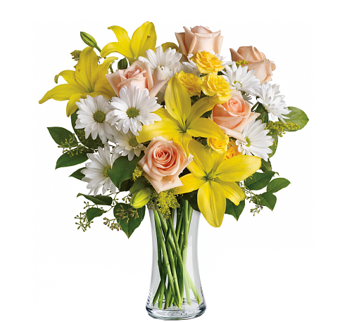 Bouquet of yellow pink and white flowers in a glass vase