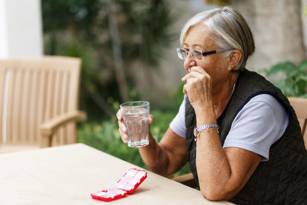 Senior woman taking vitamins and minerals