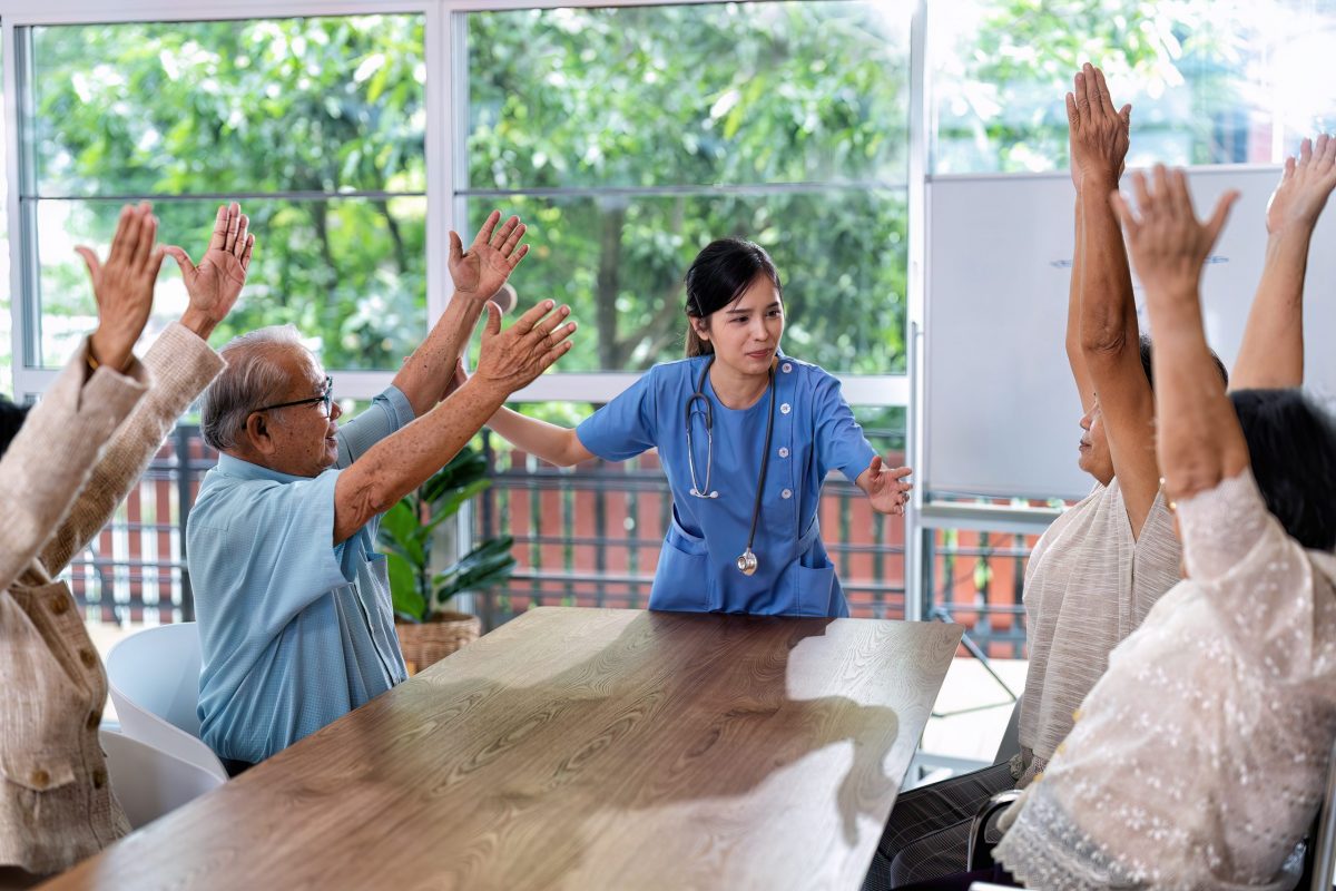 At home care service nurse caregiver take the lead to elderly person exercise in every morning