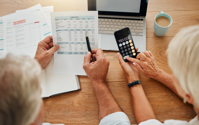 Elderly people at table exploring senior benefits in canada