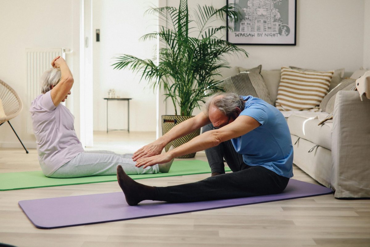older senior couple stretch yoga mat